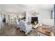 Bright living room featuring an open-concept layout, neutral walls and gray flooring at 781 Nancy Dr, The Villages, FL 32163