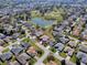 An aerial view shows the home is part of a well-planned community with lush landscaping and water features at 7812 Se 167Th Mistwood Ln, The Villages, FL 32162