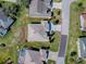 Aerial view outlining property, landscaped yard, and nearby pool, and patio at 7812 Se 167Th Mistwood Ln, The Villages, FL 32162