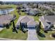 Beautiful aerial view of a single-story home with well-manicured lawn, mature landscaping, and a golf course nearby at 7812 Se 167Th Mistwood Ln, The Villages, FL 32162