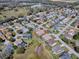This aerial shot showcases the property in a neighborhood close to a recreation center and green spaces at 7812 Se 167Th Mistwood Ln, The Villages, FL 32162
