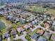 An aerial view shows the well-maintained neighborhood, with mature trees and landscaping at 7812 Se 167Th Mistwood Ln, The Villages, FL 32162