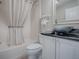 This bathroom features a tub with shower, a vessel sink, and white cabinets at 7812 Se 167Th Mistwood Ln, The Villages, FL 32162