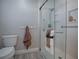 Bathroom featuring a toilet, glass shower with a towel rack, and accessories at 7812 Se 167Th Mistwood Ln, The Villages, FL 32162