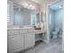 Bathroom with a dual sink vanity, a toilet in separate room, white cabinets, and a large mirror at 7812 Se 167Th Mistwood Ln, The Villages, FL 32162