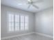 This bedroom features wood-look floors, white trim, gray walls, white shutters, and a ceiling fan at 7812 Se 167Th Mistwood Ln, The Villages, FL 32162