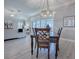 Open-concept view from dining room to living room with sliding door access to the pool at 7812 Se 167Th Mistwood Ln, The Villages, FL 32162