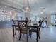 Open-concept dining room showing chandelier and view into the living room and kitchen at 7812 Se 167Th Mistwood Ln, The Villages, FL 32162