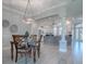 Elegant dining room with chandelier, wood table, and open view to kitchen at 7812 Se 167Th Mistwood Ln, The Villages, FL 32162
