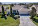 Beautiful aerial view of a home showcasing a large driveway and manicured front yard at 7812 Se 167Th Mistwood Ln, The Villages, FL 32162