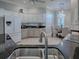 Kitchen with black countertops, white cabinetry, stainless appliances, and a breakfast nook at 7812 Se 167Th Mistwood Ln, The Villages, FL 32162