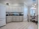 Kitchen featuring white cabinets, stainless appliances, black countertops, and a breakfast nook at 7812 Se 167Th Mistwood Ln, The Villages, FL 32162