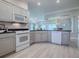 Bright kitchen with stainless appliances, granite countertops, and view to the breakfast nook at 7812 Se 167Th Mistwood Ln, The Villages, FL 32162