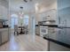 Kitchen showcasing white appliances, granite counters, custom cabinets, and an adjacent breakfast nook at 7812 Se 167Th Mistwood Ln, The Villages, FL 32162