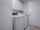 Functional laundry room with white cabinets and modern washer and dryer at 7812 Se 167Th Mistwood Ln, The Villages, FL 32162