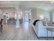 Open floor plan showcasing the living room, kitchen, and entryway with light wood flooring at 7812 Se 167Th Mistwood Ln, The Villages, FL 32162