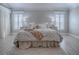 Inviting main bedroom with light wood floors, decorative lamps on nightstands, and two shuttered windows allowing natural light at 7812 Se 167Th Mistwood Ln, The Villages, FL 32162