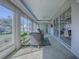 Enclosed sun room with wall of windows providing backyard views and great natural light at 7812 Se 167Th Mistwood Ln, The Villages, FL 32162