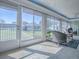 Sun room featuring multiple windows and wicker chairs at 7812 Se 167Th Mistwood Ln, The Villages, FL 32162