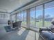 Relaxing sunroom featuring a lake view through large windows and comfortable seating at 7812 Se 167Th Mistwood Ln, The Villages, FL 32162