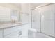 Bright bathroom featuring a granite countertop, vanity, toilet, and glass-enclosed shower at 9729 Lost Creek Dr, Winter Garden, FL 34787