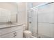 Bright bathroom featuring a glass shower, vanity with granite countertop, and modern fixtures at 9729 Lost Creek Dr, Winter Garden, FL 34787