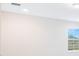 An empty bedroom featuring neutral paint, a large window, carpeted floors, and overhead lighting at 9729 Lost Creek Dr, Winter Garden, FL 34787