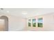 Bright bedroom features three large windows with lake views and partial view of an en-suite bathroom at 9729 Lost Creek Dr, Winter Garden, FL 34787