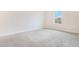 Bedroom featuring neutral carpeting and a large window providing natural light at 9729 Lost Creek Dr, Winter Garden, FL 34787
