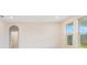 Bright bedroom features three large windows and partial view of an en-suite bathroom at 9729 Lost Creek Dr, Winter Garden, FL 34787