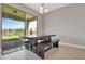 Dining area features a modern table and bench with access to the outdoor patio and water views at 9729 Lost Creek Dr, Winter Garden, FL 34787