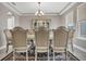 Formal dining room with elegant chandelier, decorative china cabinet and seating for six at 9729 Lost Creek Dr, Winter Garden, FL 34787