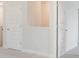 Hallway featuring neutral paint color and doors, with neutral carpeting on the floor at 9729 Lost Creek Dr, Winter Garden, FL 34787