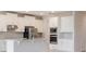 Bright kitchen features stainless steel appliances, granite countertops, and white cabinets at 9729 Lost Creek Dr, Winter Garden, FL 34787