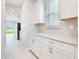 Open-concept kitchen features white cabinets and countertops, with a view of the lake and dining area at 9729 Lost Creek Dr, Winter Garden, FL 34787