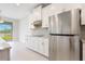 Bright kitchen features white cabinets, stainless steel appliances, and a view of the lake at 9729 Lost Creek Dr, Winter Garden, FL 34787