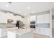 Bright kitchen features stainless steel appliances, granite countertops, and white cabinets at 9729 Lost Creek Dr, Winter Garden, FL 34787