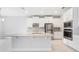 Modern kitchen featuring stainless steel appliances, granite countertops, and white cabinets at 9729 Lost Creek Dr, Winter Garden, FL 34787