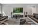 Spacious living room with stylish furnishings and a modern entertainment center at 9729 Lost Creek Dr, Winter Garden, FL 34787