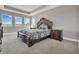 Main bedroom with tray ceilings and three large windows offering plenty of natural light at 9729 Lost Creek Dr, Winter Garden, FL 34787