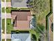 Birds eye view of property featuring a backyard pool, screened in patio, well manicured lawn and mature trees at 995 Hidden Blf, Clermont, FL 34711