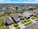 Aerial view of homes with well-manicured lawns and brick driveways in a peaceful neighborhood at 995 Hidden Blf, Clermont, FL 34711