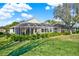 Spacious backyard with lush landscaping and a screened lanai, perfect for outdoor living at 995 Hidden Blf, Clermont, FL 34711