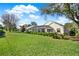 Expansive backyard featuring a well-maintained lawn, lush landscaping, and a screened lanai at 995 Hidden Blf, Clermont, FL 34711