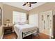 Comfortable bedroom featuring hardwood floors, fan, and a large window with blinds at 995 Hidden Blf, Clermont, FL 34711