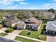 Charming single Gathering home featuring a well manicured lawn, brick driveway and lush landscaping at 995 Hidden Blf, Clermont, FL 34711