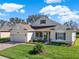 Beautiful single-Gathering home with well-kept lawn, brick driveway, lush landscaping, and inviting front porch at 995 Hidden Blf, Clermont, FL 34711