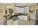 Open kitchen showcasing granite countertops, white cabinets, and tile flooring at 995 Hidden Blf, Clermont, FL 34711