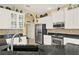 This kitchen features stainless steel appliances, granite counters, white cabinets, and decorative backsplash at 995 Hidden Blf, Clermont, FL 34711
