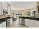 Bright, modern kitchen with stainless steel appliances and a view into the open living area at 995 Hidden Blf, Clermont, FL 34711